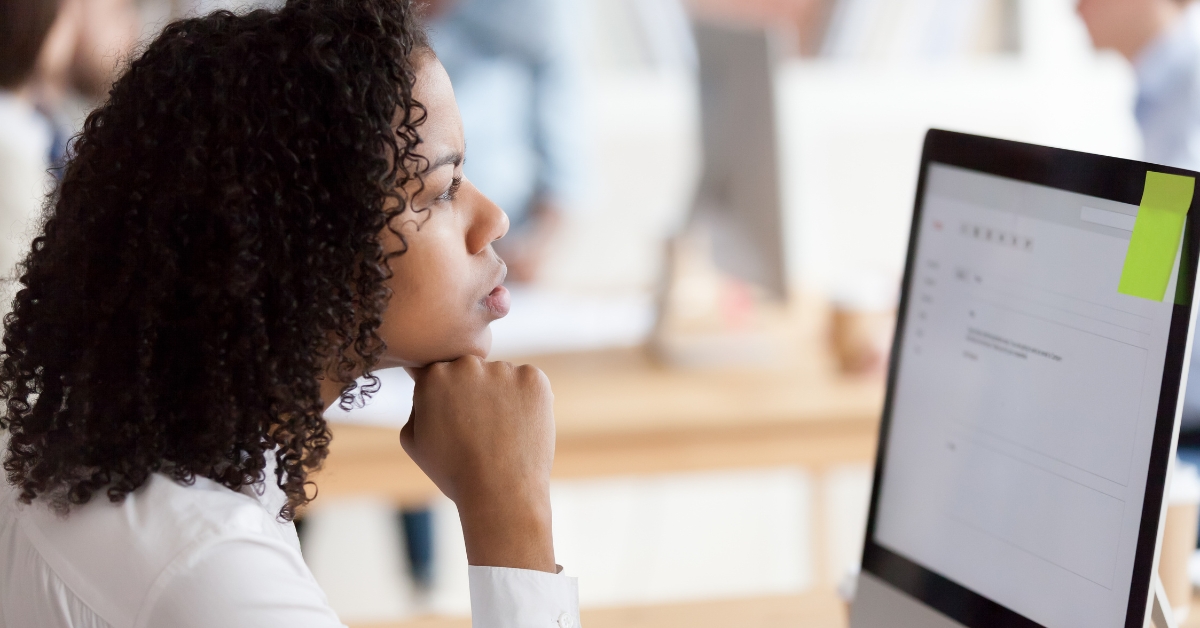 Female employee thinking about the simulated phishing test